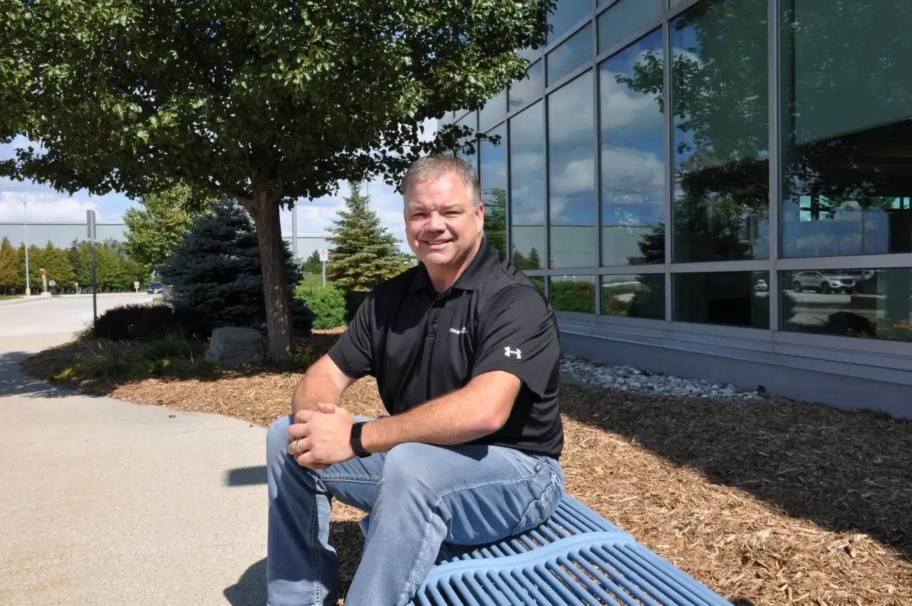 Photo of Todd Thompson sitting on a bench.